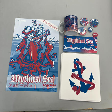 1/11, display of all items made for this project including a poster, screen prints, booklet, mug, and buttons.
